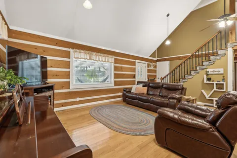 a living room with furniture and a floor to ceiling window
