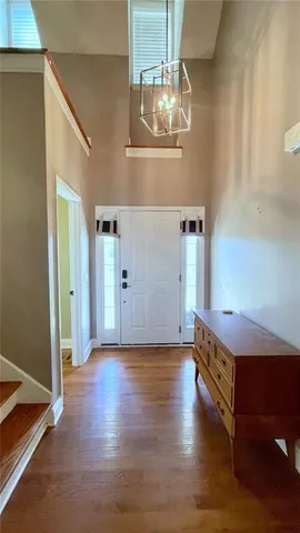 a view of entryway and hall with wooden floor