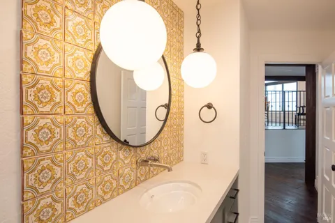 an entryway with wooden floor and mirror