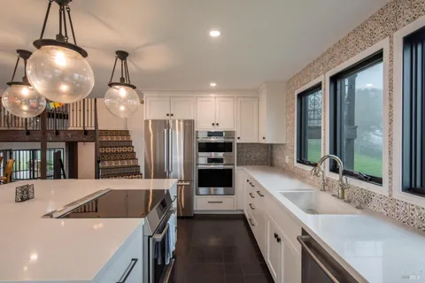 a kitchen with a sink stove and refrigerator