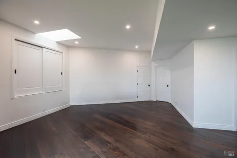 an empty room with wooden floor