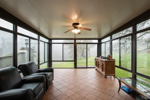 a living room with furniture and a floor to ceiling window