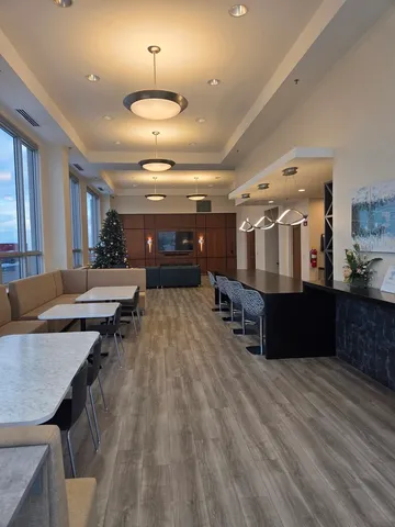 a room with lots of wooden furniture and a chandelier