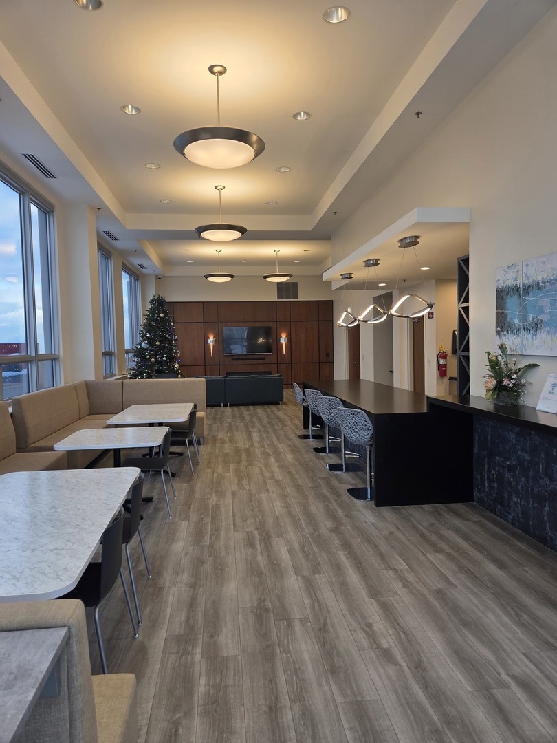 1841 South Calumet Avenue, Unit 707 Chicago, IL 60616 - Photo 12 of 14 a room with lots of wooden furniture and a chandelier