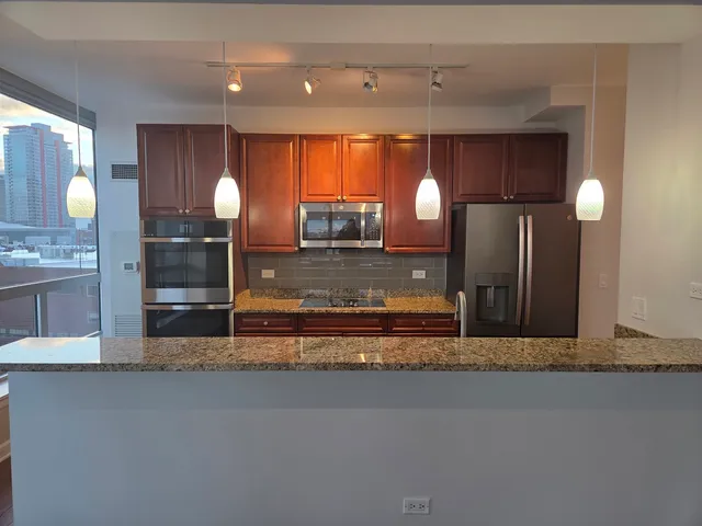 a view of a kitchen with a sink and window