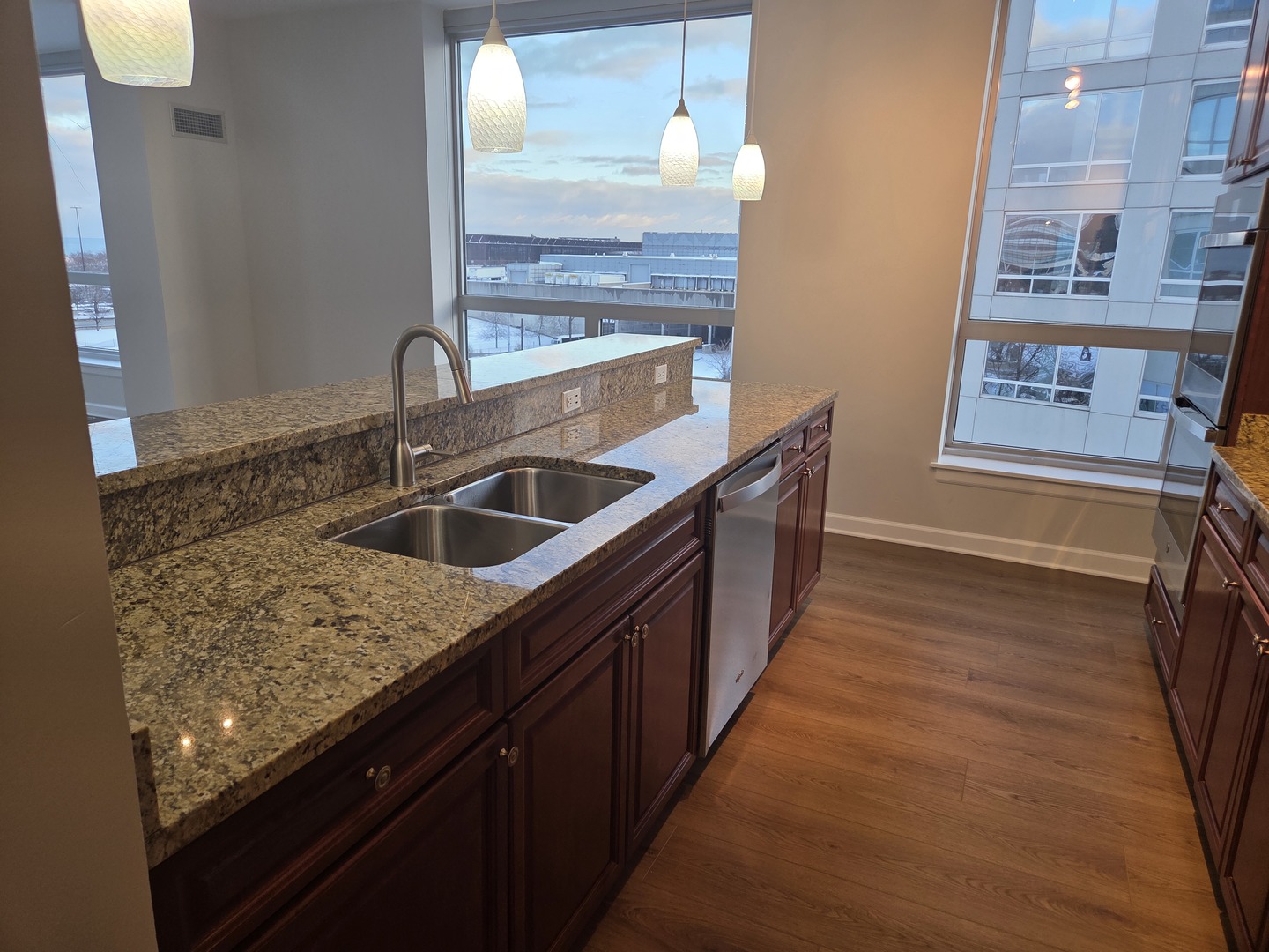 1841 South Calumet Avenue, Unit 707 Chicago, IL 60616 - Photo 6 of 14 a kitchen with stainless steel appliances granite countertop a sink and a refrigerator