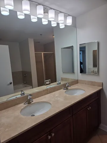 a bathroom with a sink double vanity and a mirror