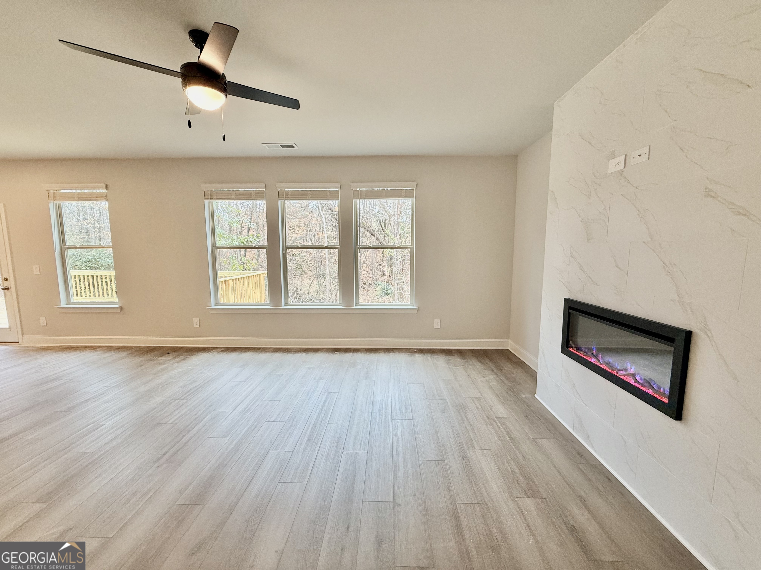 1023 Boulder Drive Gray, GA 31032 - Photo 17 of 52 an empty room with windows and ceiling fan