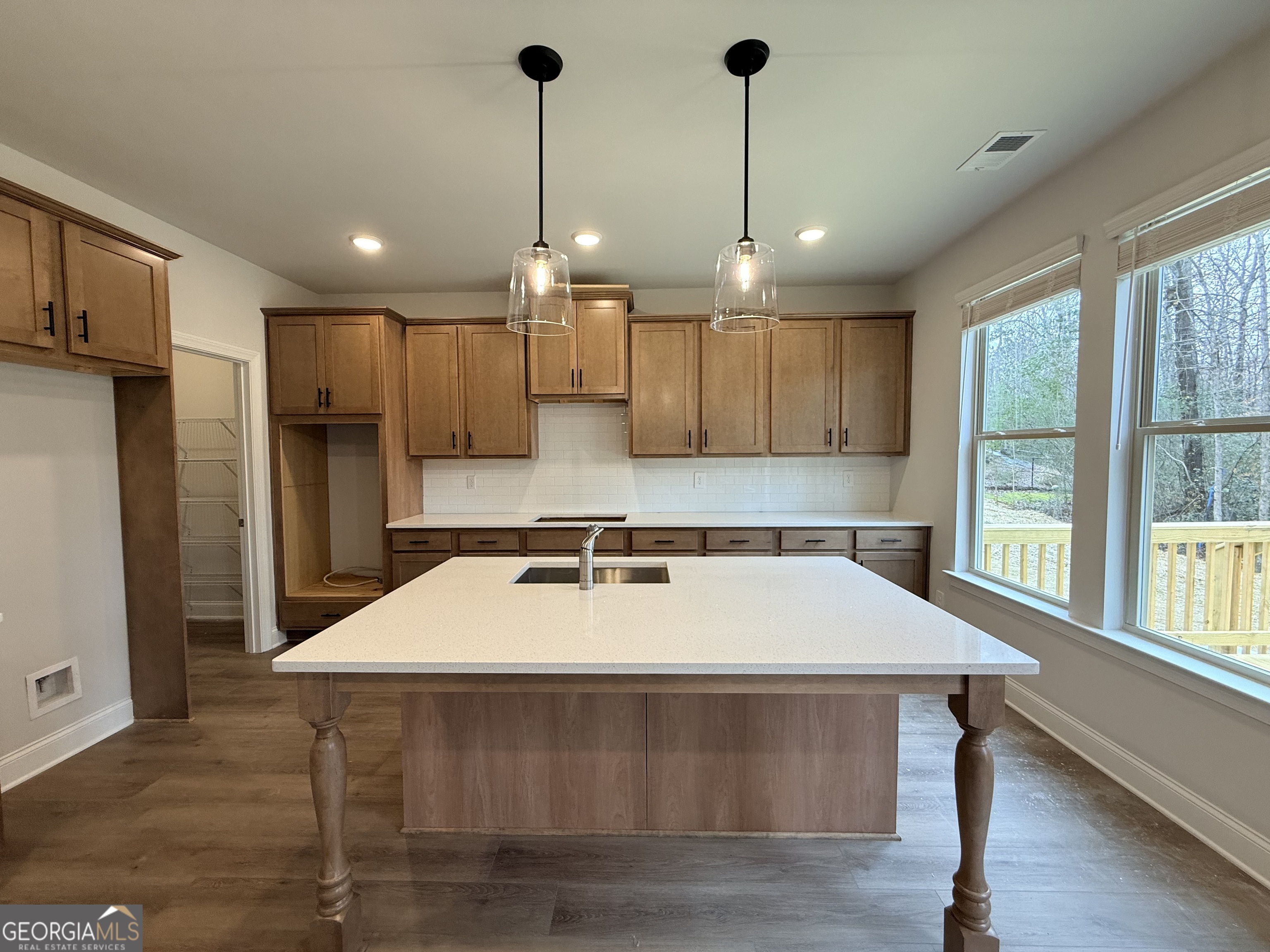 1023 Boulder Drive Gray, GA 31032 - Photo 21 of 52 a kitchen with kitchen island a sink stainless steel appliances and window