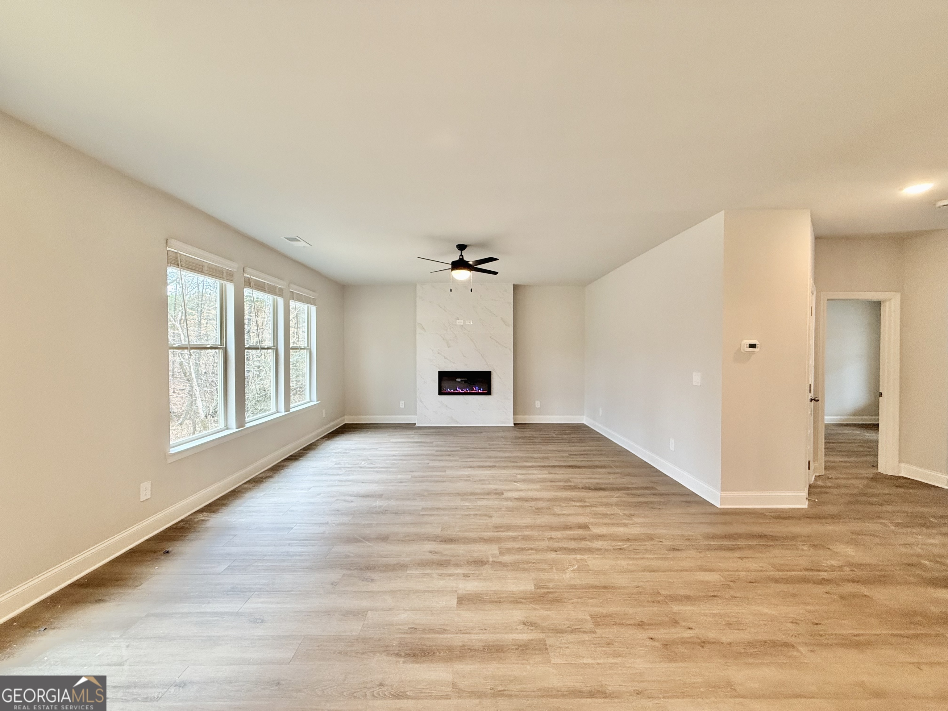 1023 Boulder Drive Gray, GA 31032 - Photo 32 of 52 wooden floor in an empty room with a window