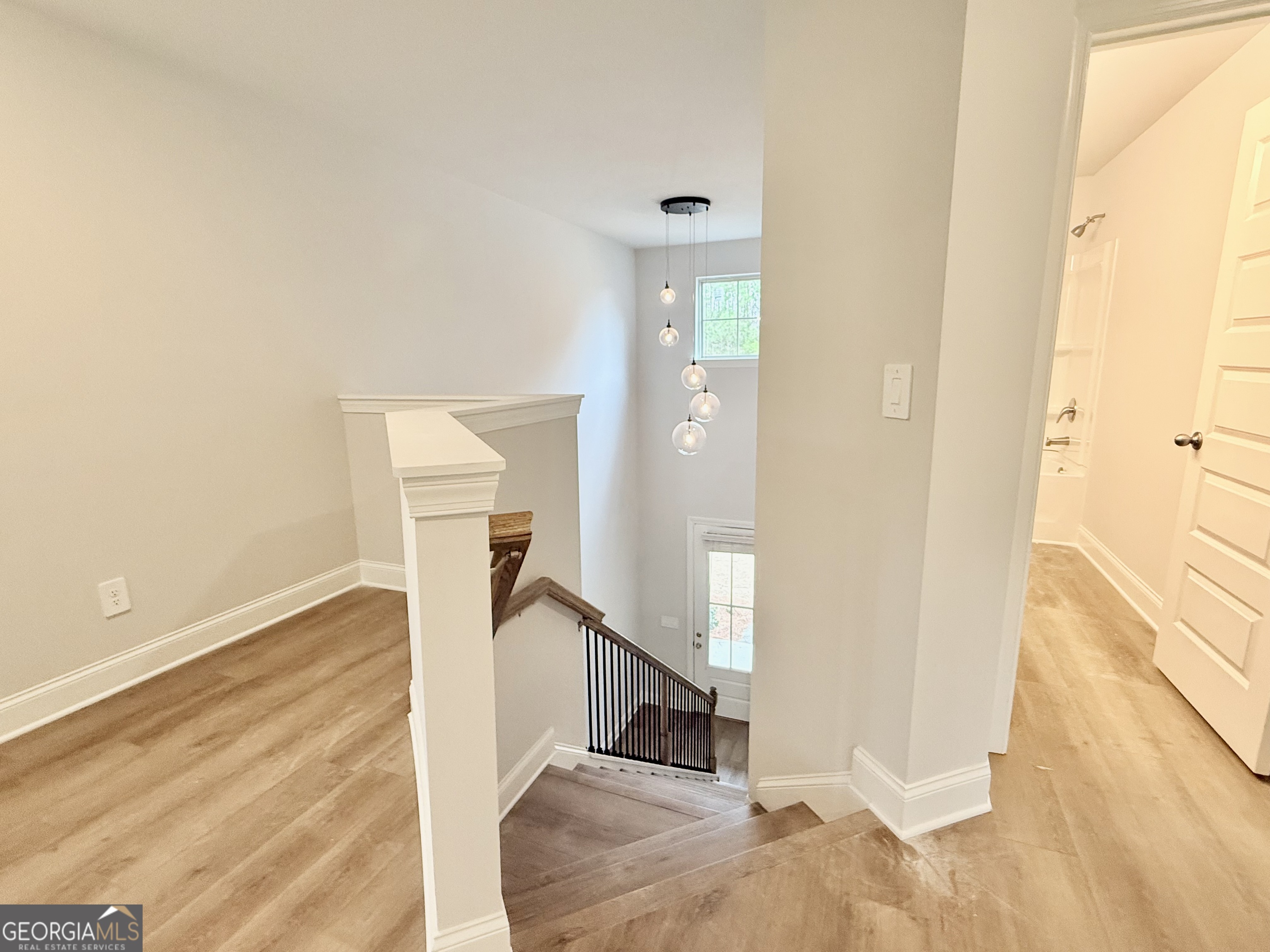 1023 Boulder Drive Gray, GA 31032 - Photo 36 of 52 a view of a livingroom with wooden floor and stairs