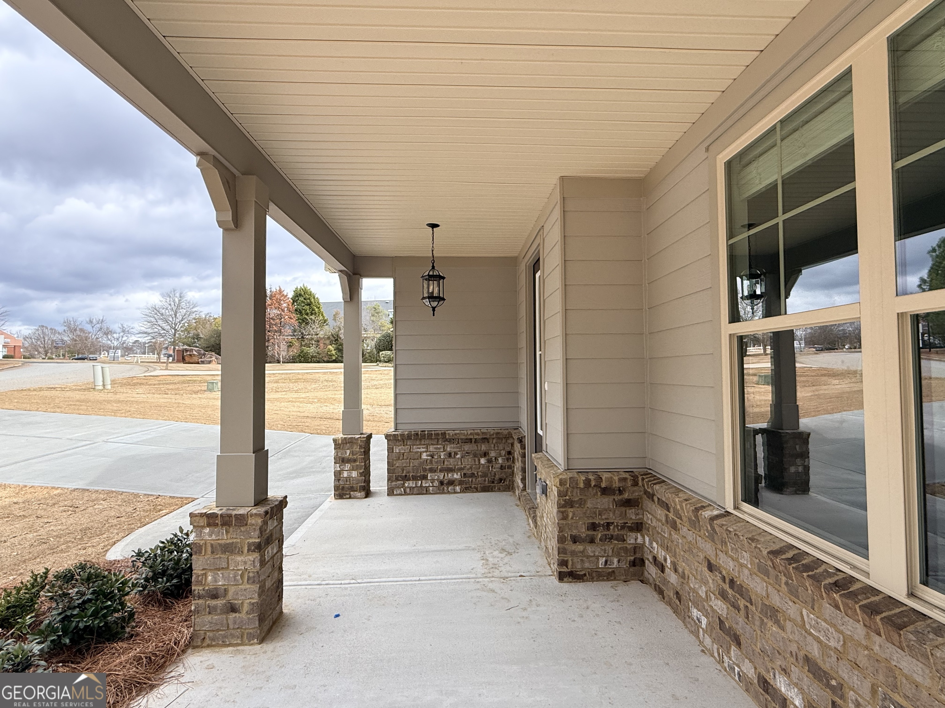 1023 Boulder Drive Gray, GA 31032 - Photo 5 of 52 a view of a terrace with wooden floor and floor to ceiling window