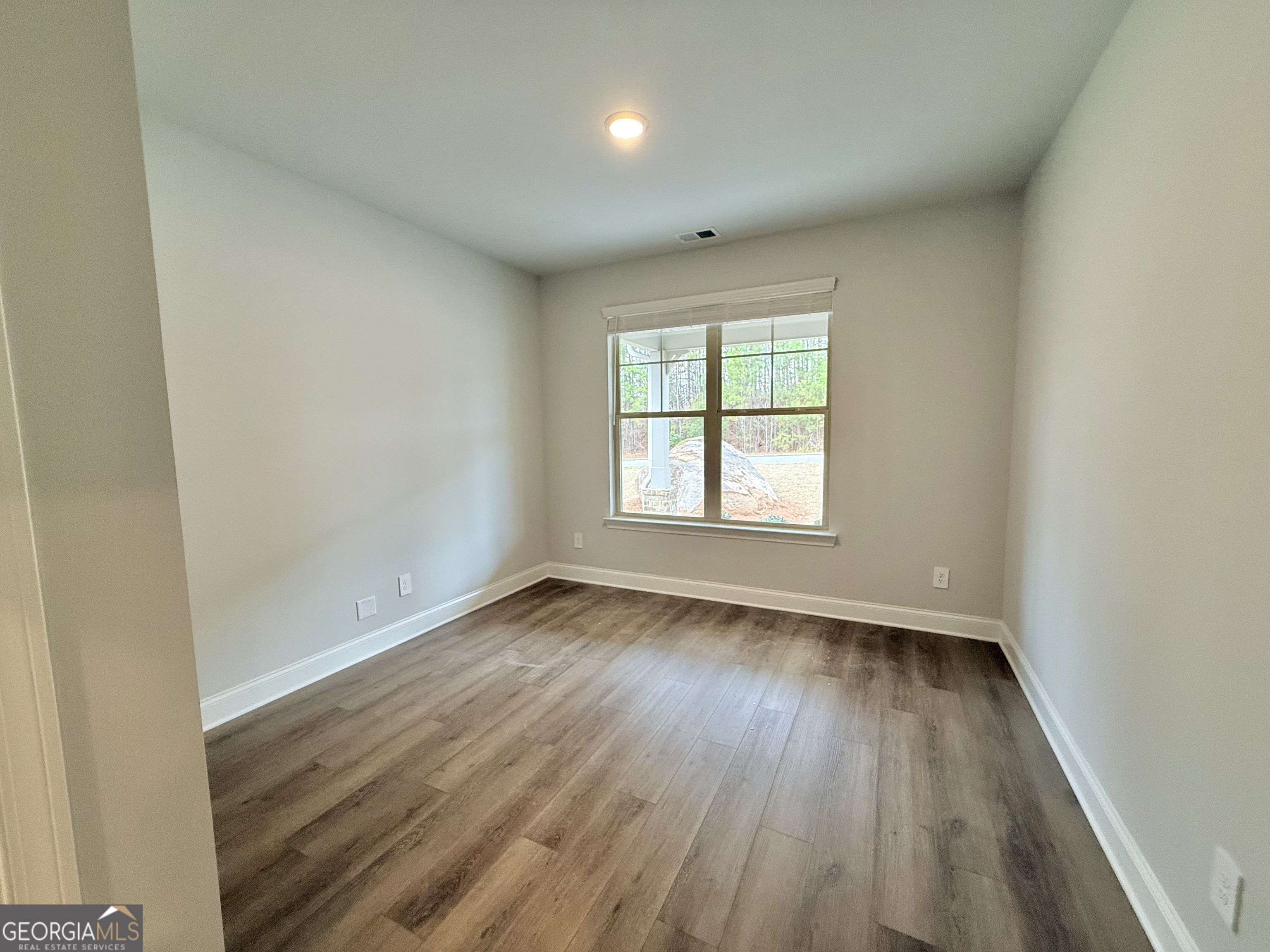 1023 Boulder Drive Gray, GA 31032 - Photo 9 of 52 an empty room with wooden floor and windows