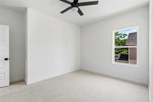an empty room with windows and closet