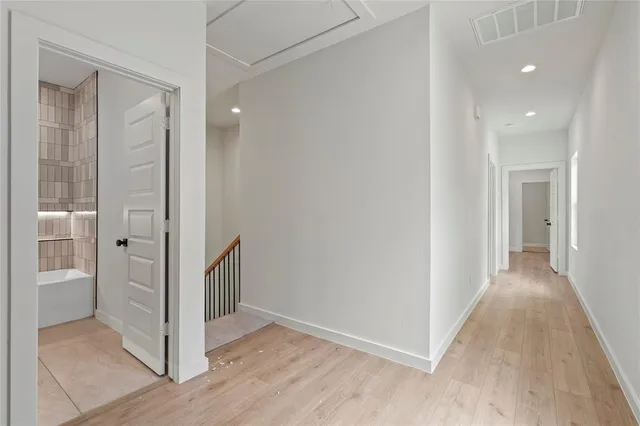 a view of a hallway with wooden floor