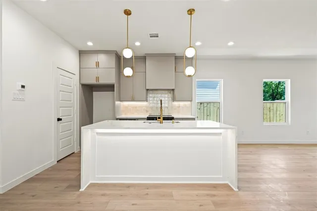 a view of a kitchen with a stove and a wooden floors