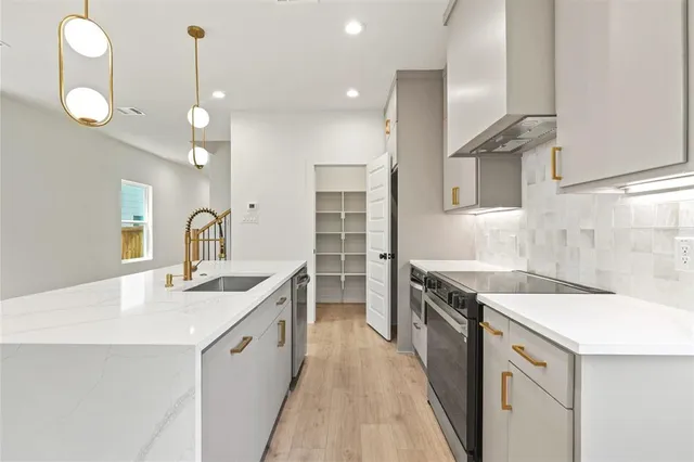 a kitchen with a sink and stove