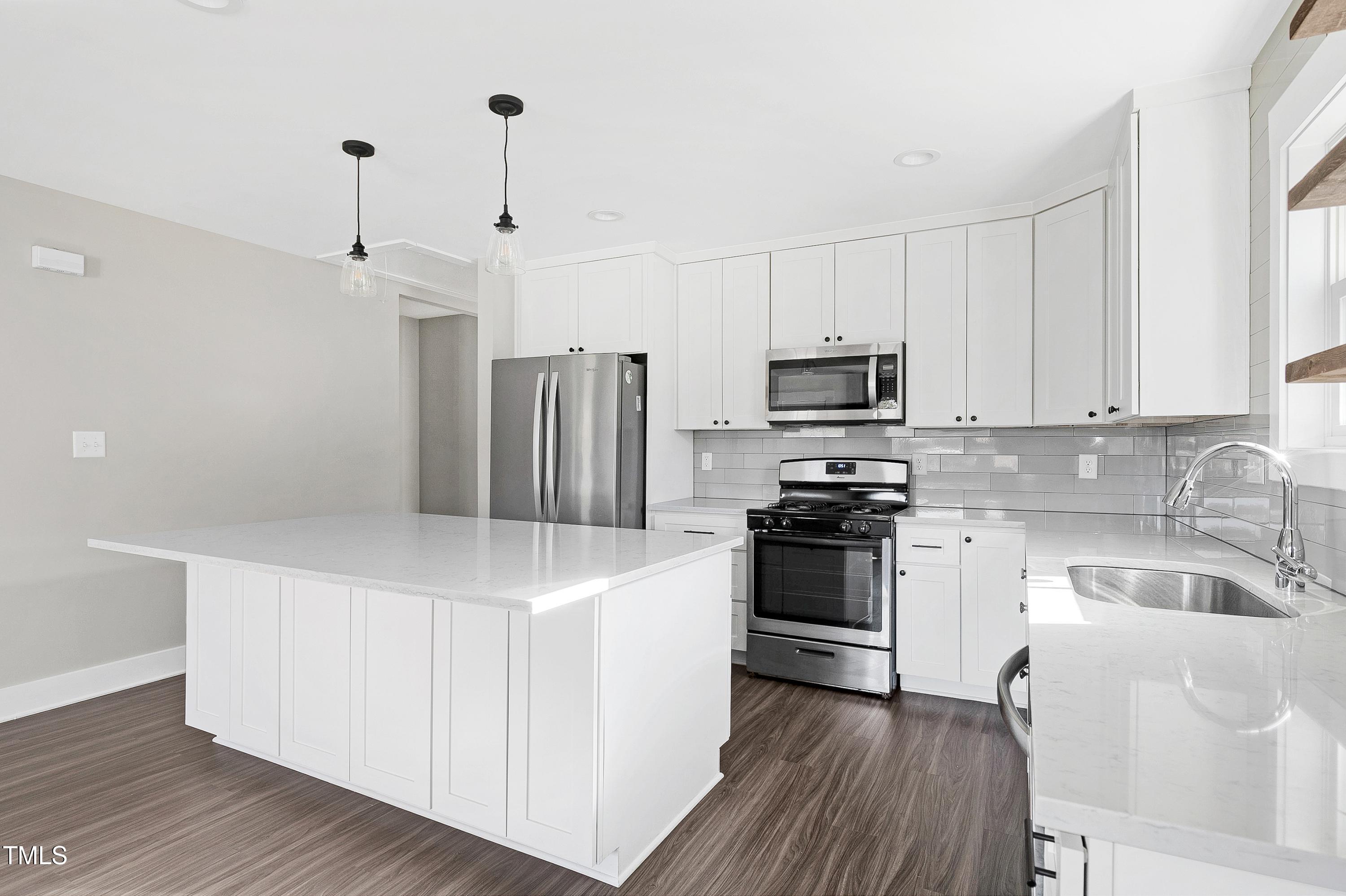 621 Coleman Street Raleigh, NC 27610 - Photo 13 of 42 a kitchen with granite countertop a refrigerator stove and sink