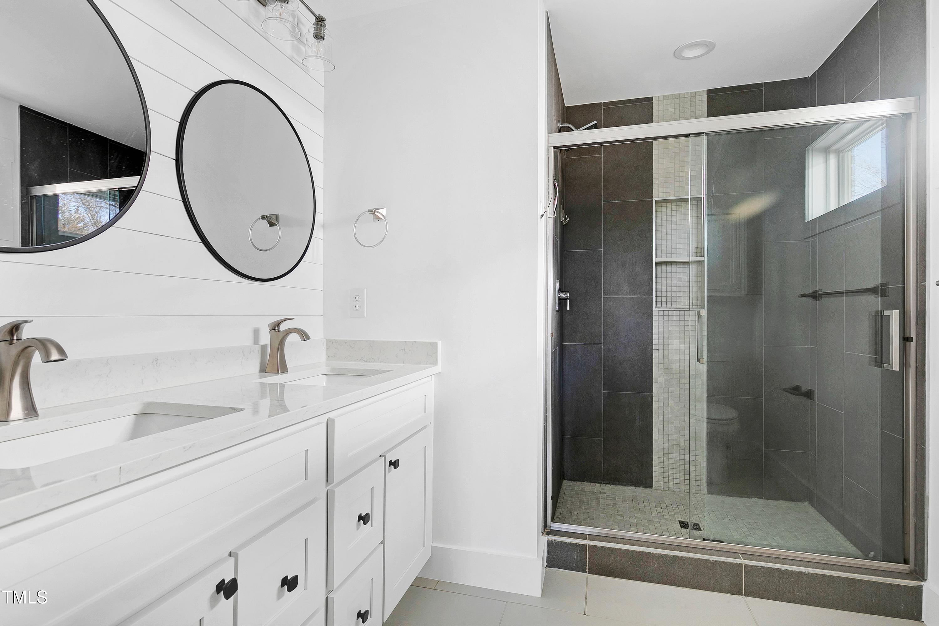 621 Coleman Street Raleigh, NC 27610 - Photo 18 of 42 a bathroom with a sink and a mirror