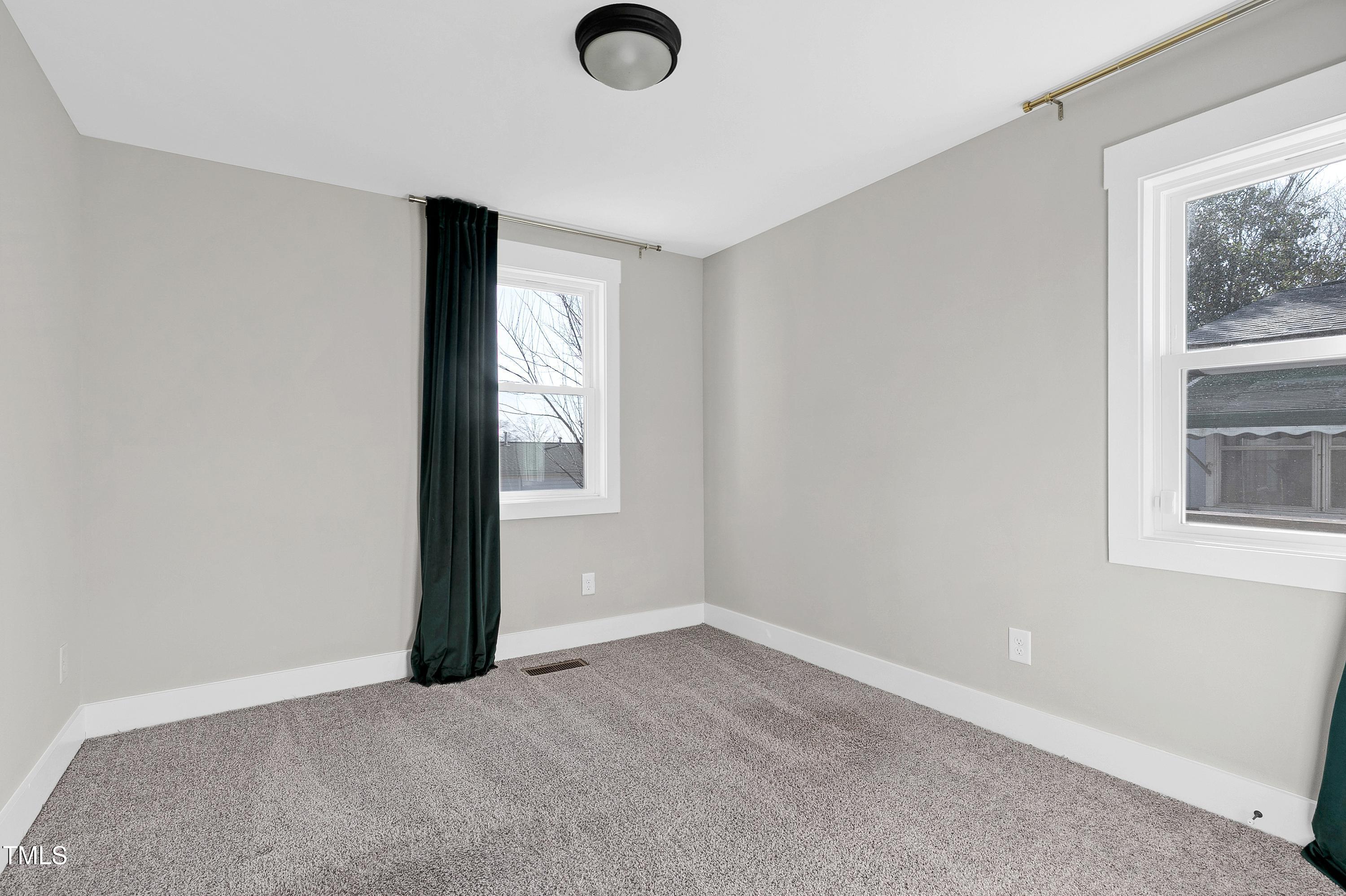 621 Coleman Street Raleigh, NC 27610 - Photo 24 of 42 an empty room with windows and closet