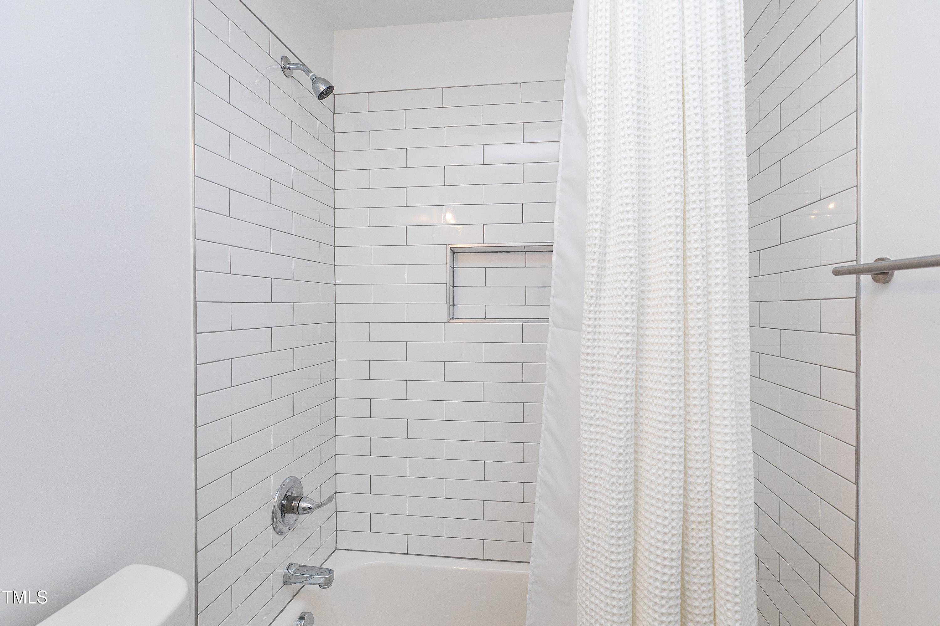 621 Coleman Street Raleigh, NC 27610 - Photo 28 of 42 a bathroom with a shower and a toilet