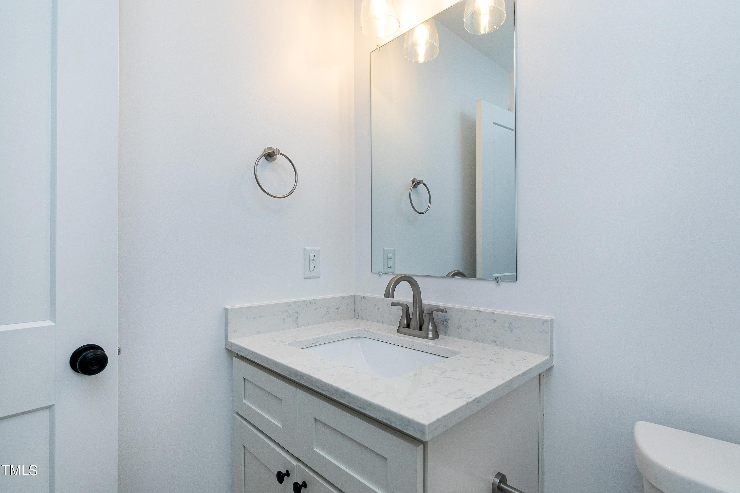 621 Coleman Street Raleigh, NC 27610 - Photo 29 of 42 a bathroom with a sink vanity and toilet
