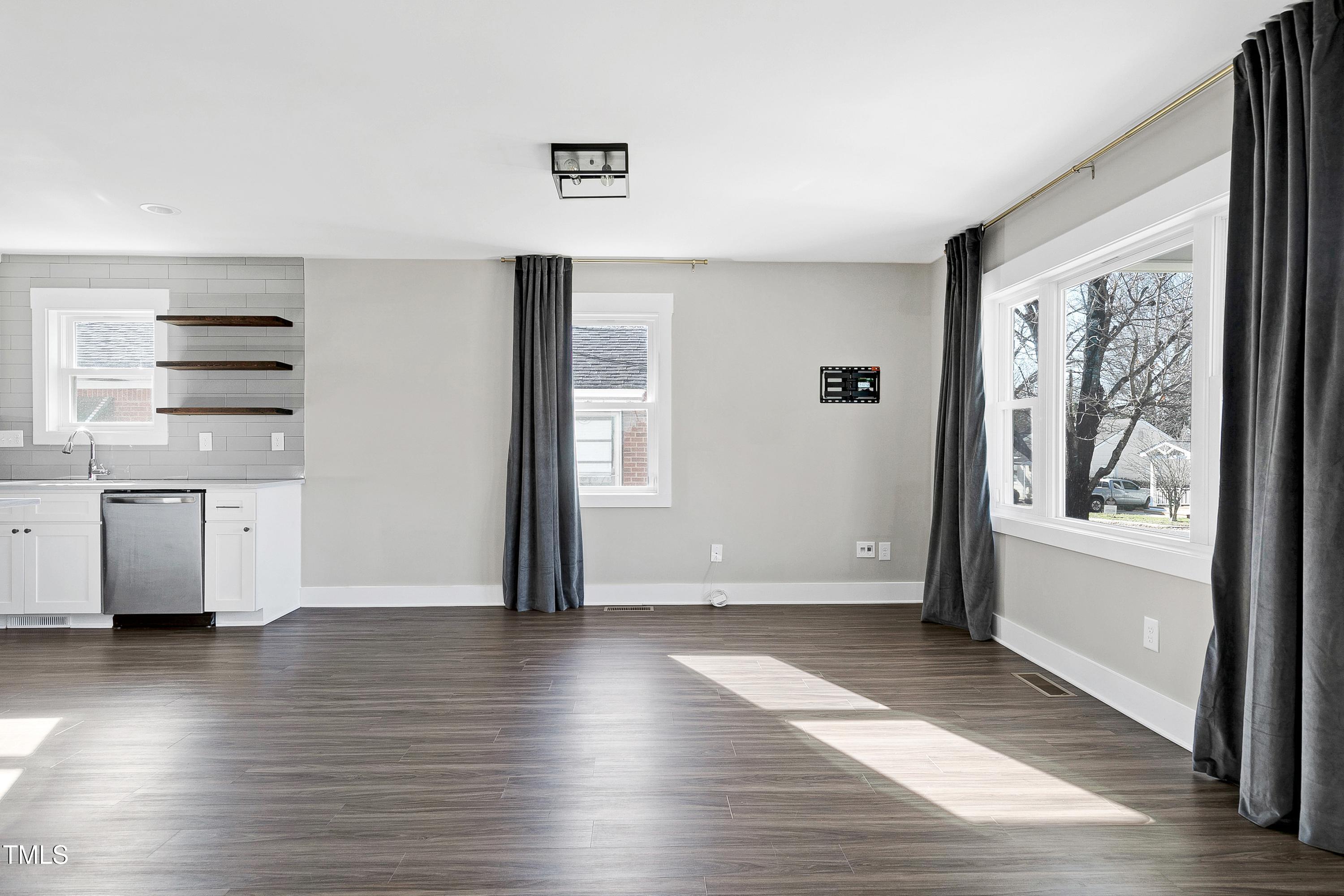 621 Coleman Street Raleigh, NC 27610 - Photo 7 of 42 a view of empty room with wooden floor and fan