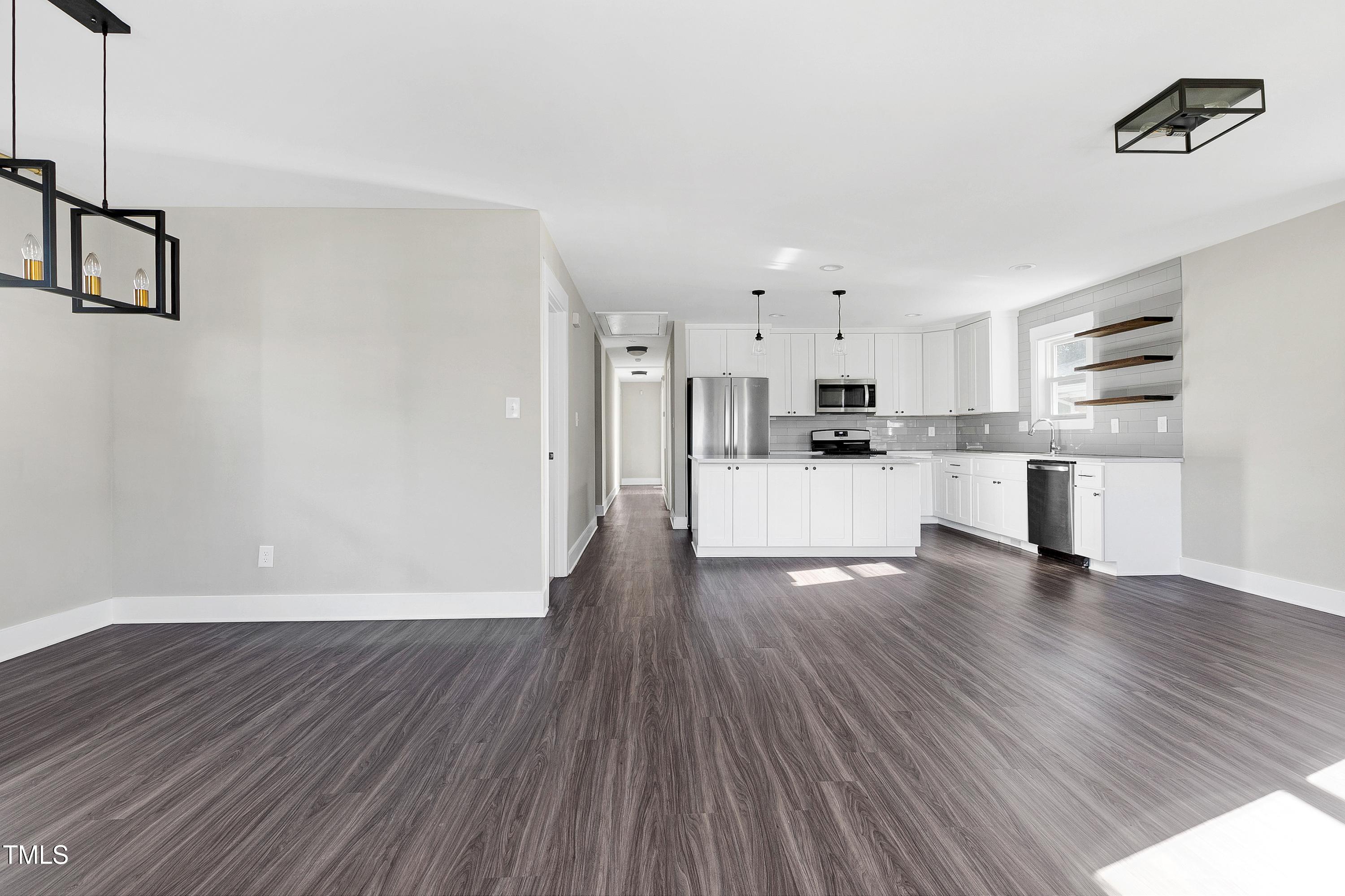 621 Coleman Street Raleigh, NC 27610 - Photo 9 of 42 a view of a kitchen with wooden floor and electronic appliances
