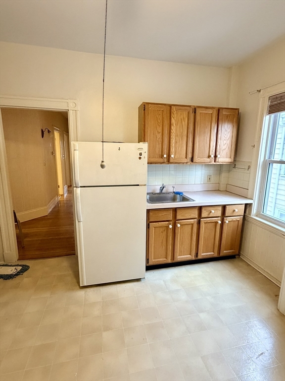25 Congreve Street, Unit 2 Boston, MA 02131 - Photo 7 of 8 a kitchen with a refrigerator a stove top oven a sink and a window