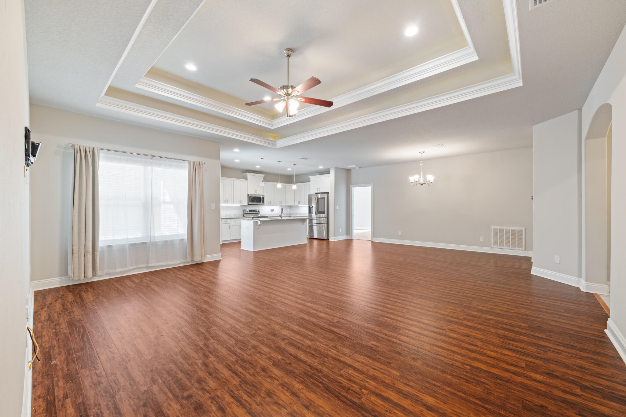7287 Gordon Evans Road Navarre, FL 32566 - Photo 14 of 45 a view of an empty room with wooden floor and a window