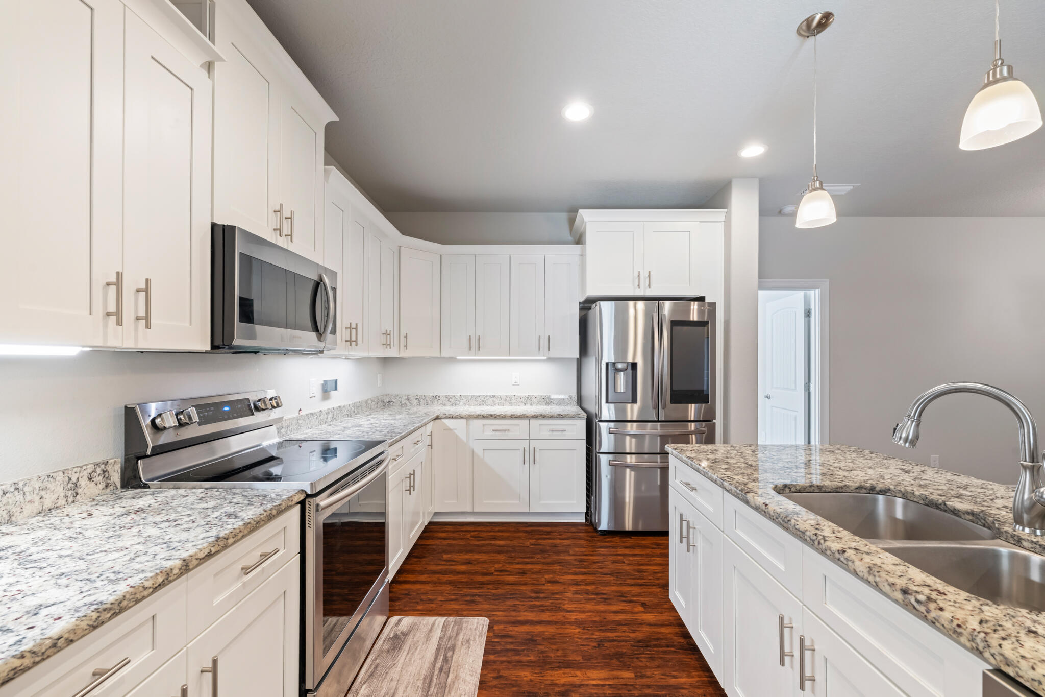 7287 Gordon Evans Road Navarre, FL 32566 - Photo 16 of 45 a kitchen with stainless steel appliances granite countertop a sink stove and refrigerator