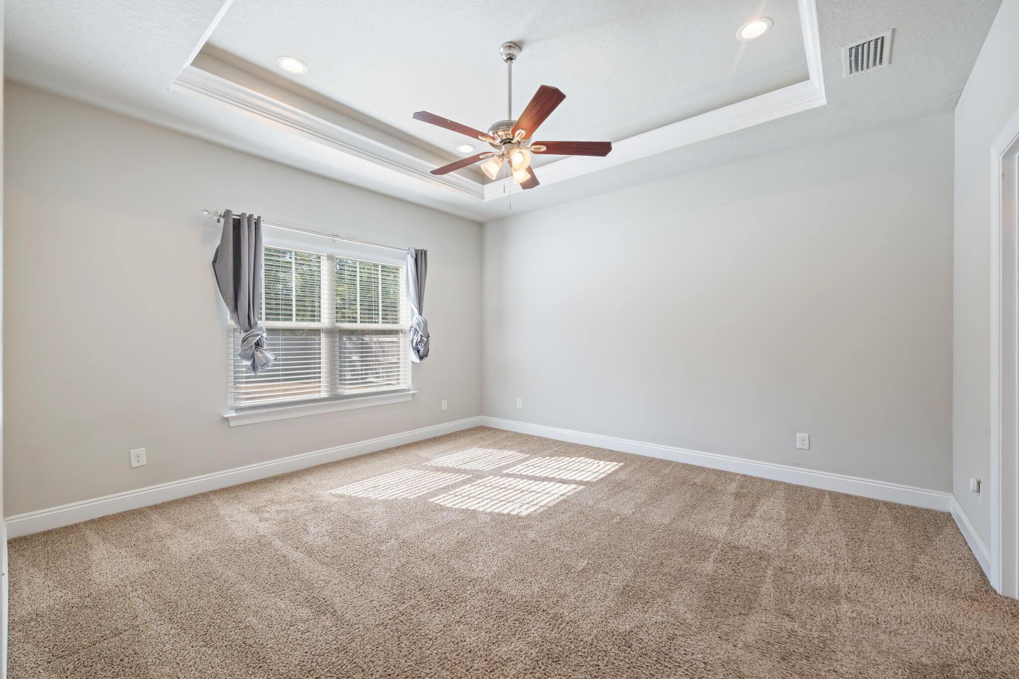 7287 Gordon Evans Road Navarre, FL 32566 - Photo 21 of 45 an empty room with windows and fan