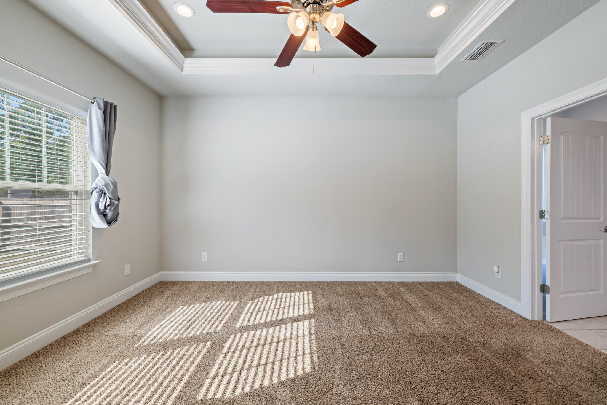 7287 Gordon Evans Road Navarre, FL 32566 - Photo 22 of 45 an empty room with windows and fan