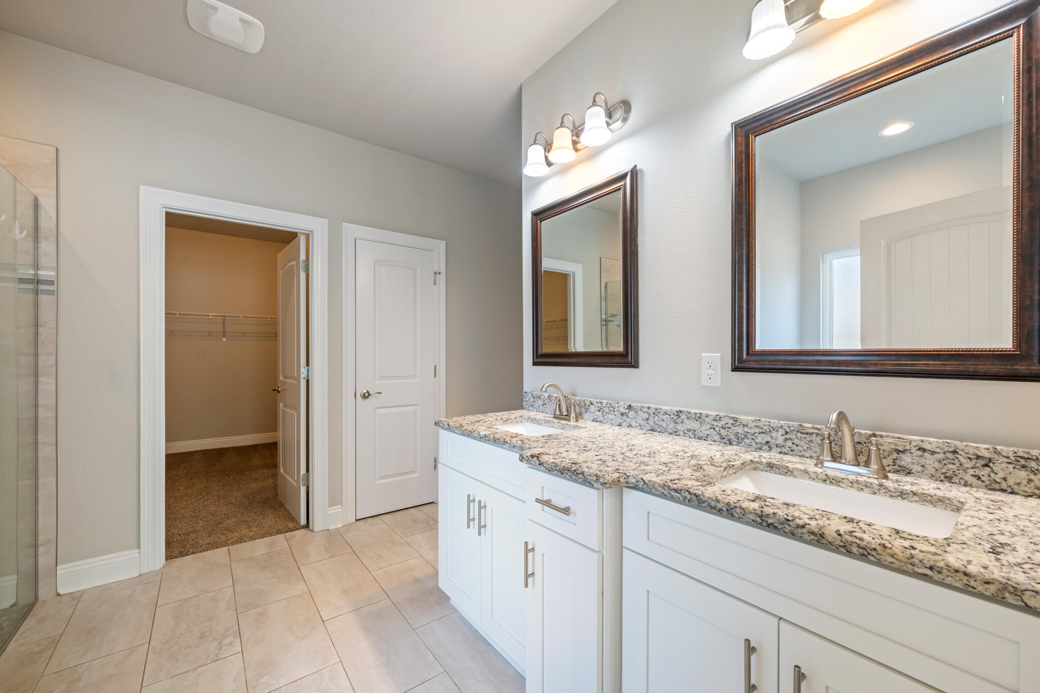 7287 Gordon Evans Road Navarre, FL 32566 - Photo 25 of 45 a bathroom with a granite countertop double vanity sink and a mirror