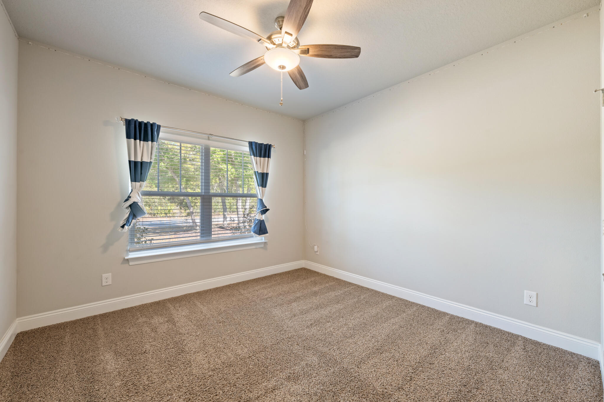 7287 Gordon Evans Road Navarre, FL 32566 - Photo 35 of 45 an empty room with a window and a fan