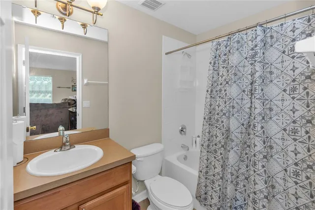 a bathroom with a toilet a sink and a mirror