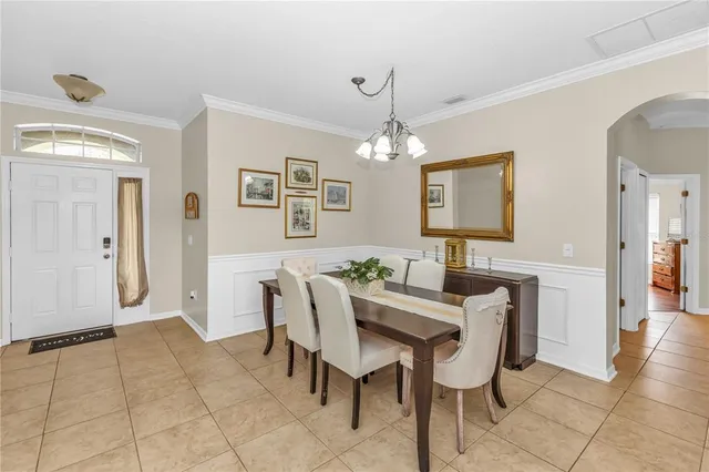 a view of a dining room with furniture and chandelier