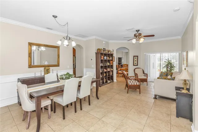 a view of a dining room with furniture and a chandelier