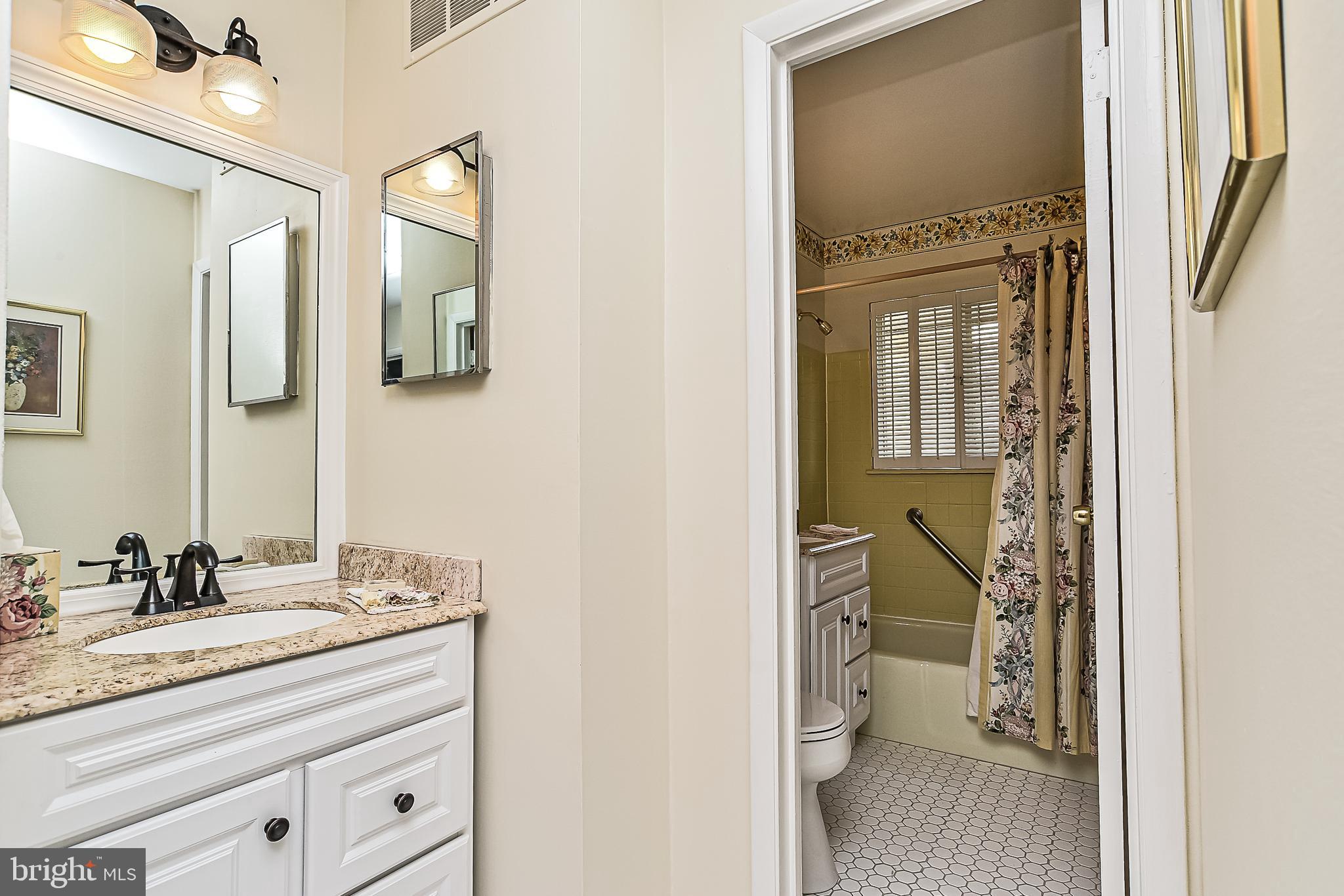 8605 Briarcroft Lane Laurel, MD 20708 - Photo 16 of 38 Full updated bath on main offers two vanities.