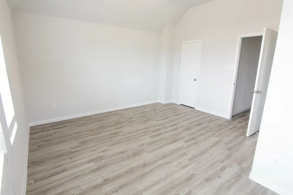 an empty room with wooden floor