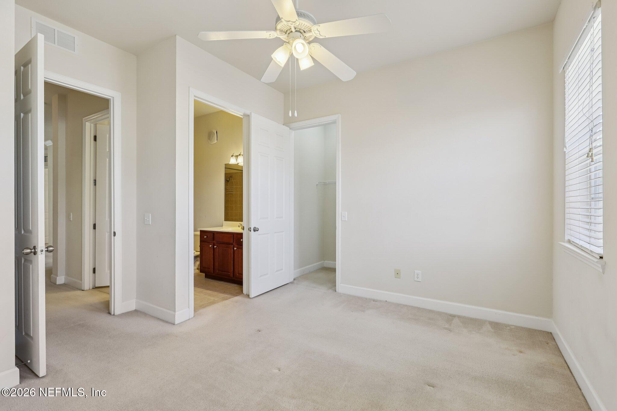 2035 Secret Garden Lane, Unit 505 Fleming Island, FL 32003 - Photo 17 of 47 an empty room with a ceiling fan and a window