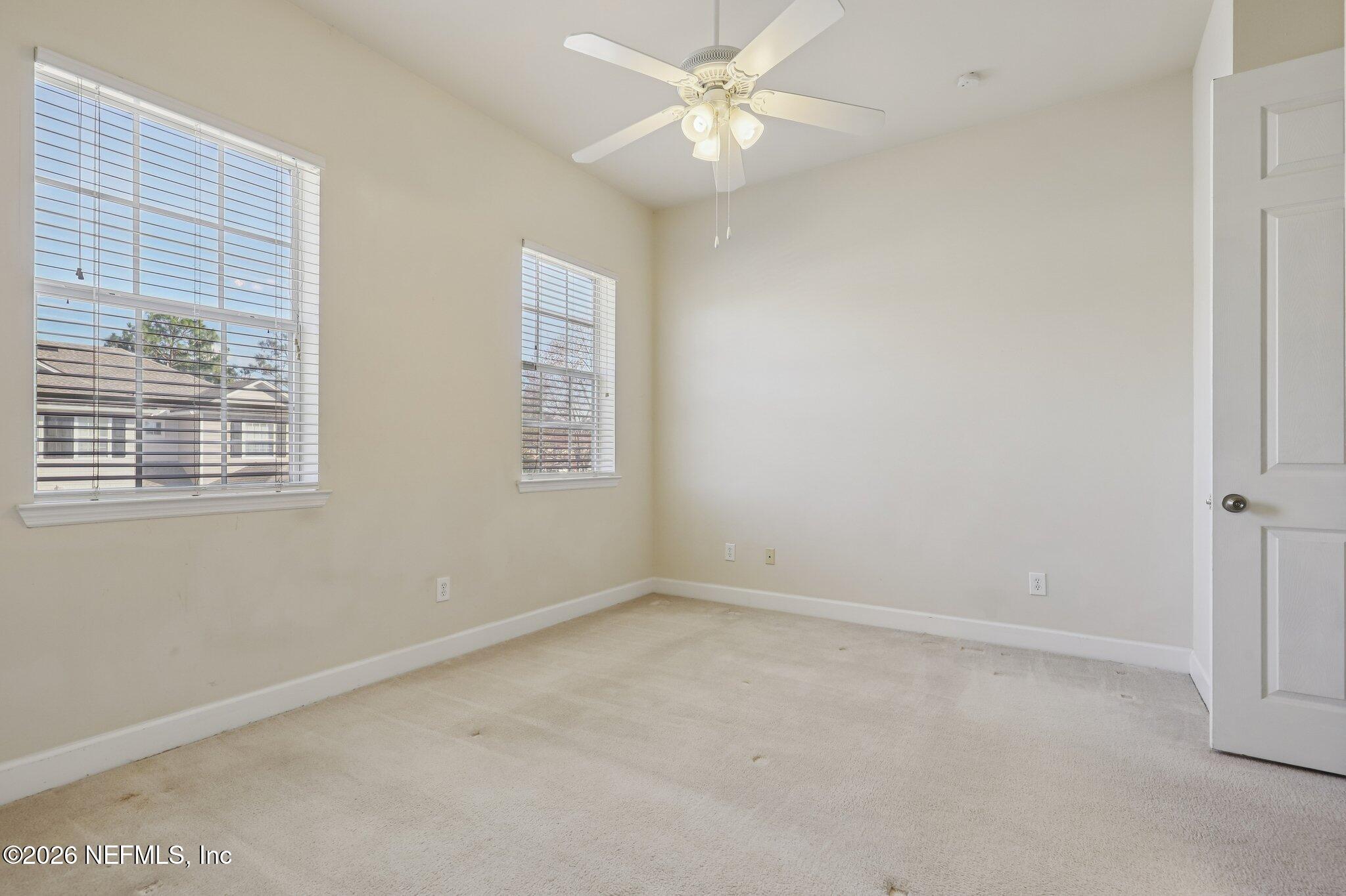 2035 Secret Garden Lane, Unit 505 Fleming Island, FL 32003 - Photo 18 of 47 an empty room with a window and a fan