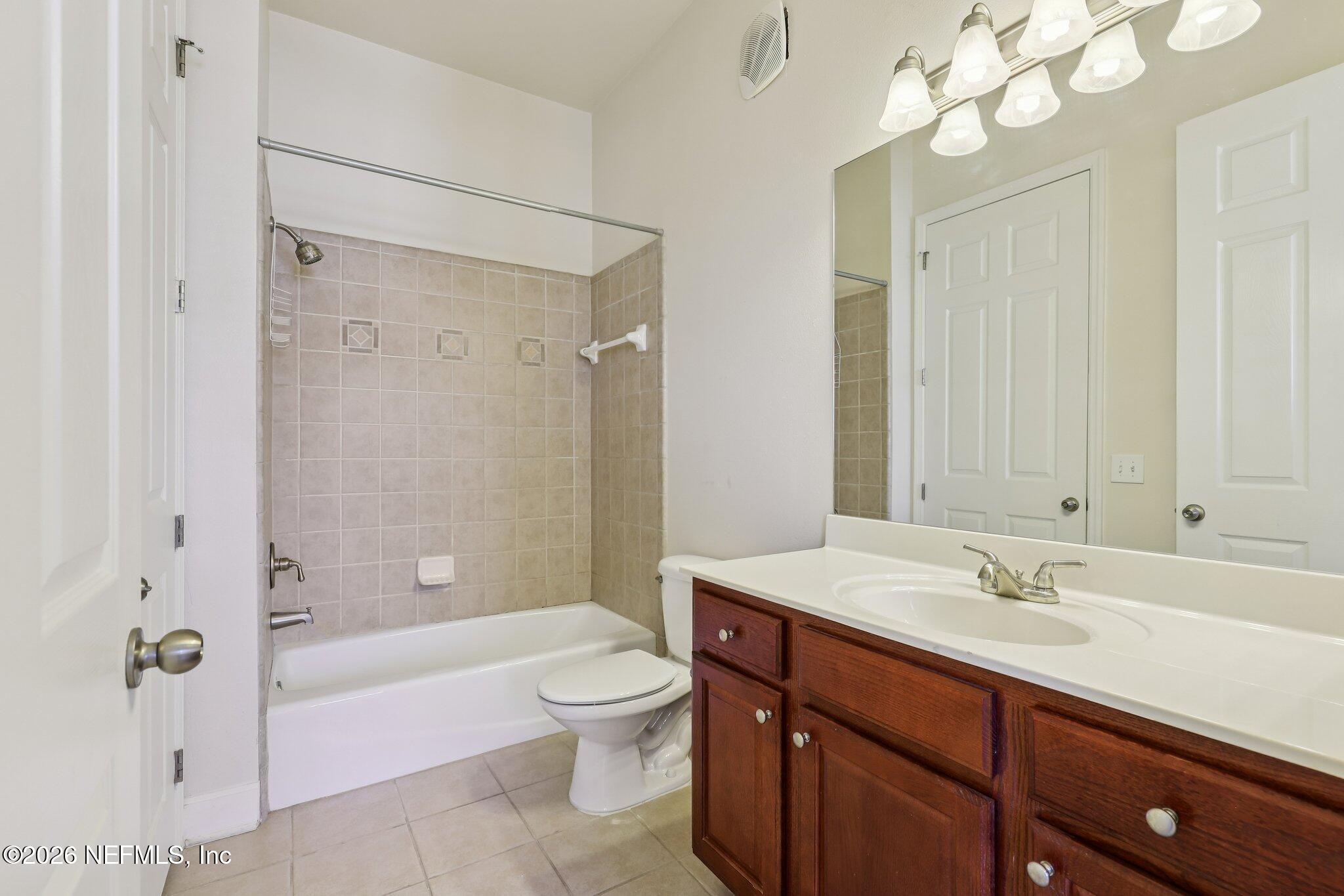 2035 Secret Garden Lane, Unit 505 Fleming Island, FL 32003 - Photo 19 of 47 a bathroom with a sink a toilet and shower