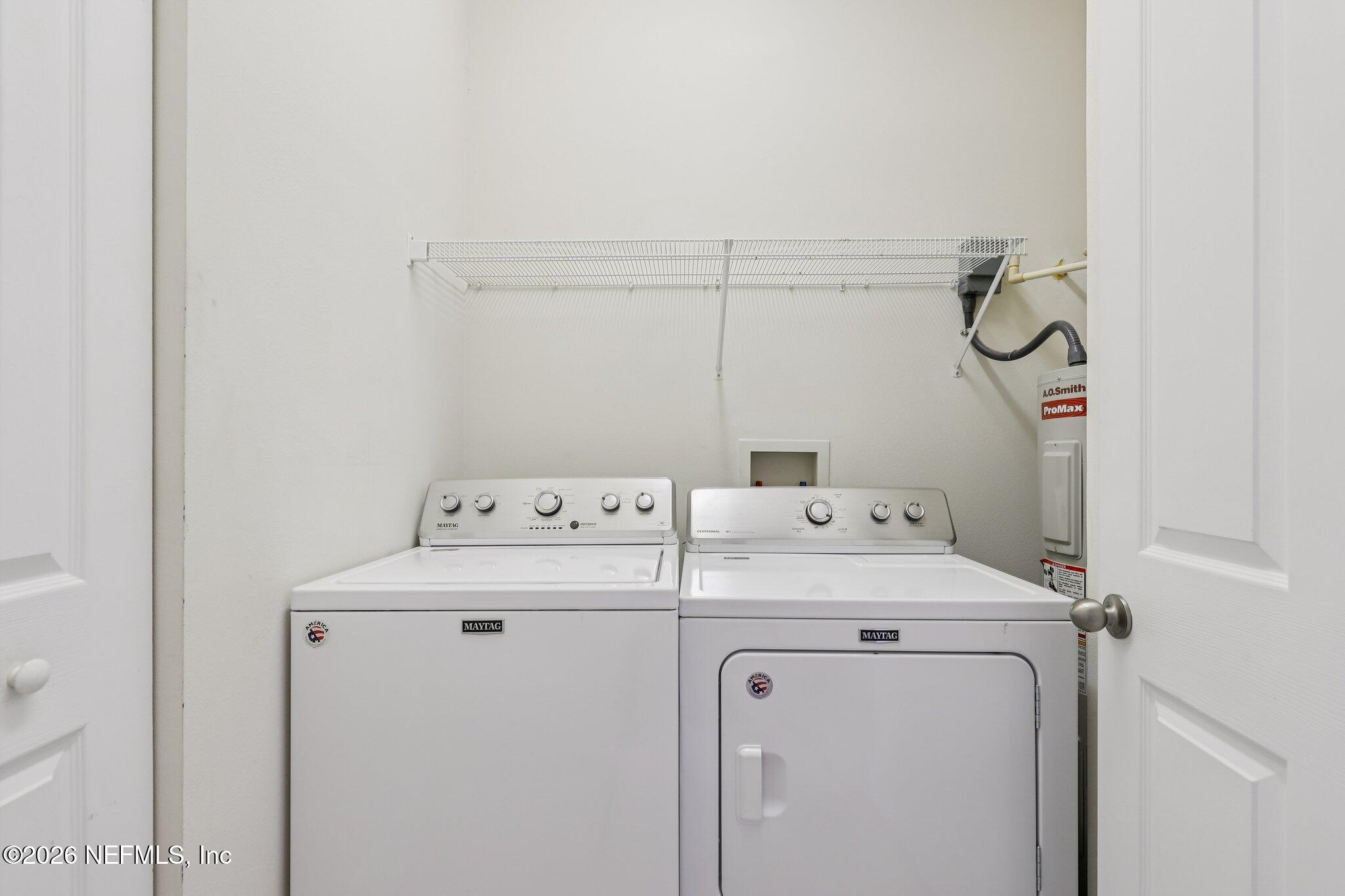 2035 Secret Garden Lane, Unit 505 Fleming Island, FL 32003 - Photo 20 of 47 a utility room with dryer and washer