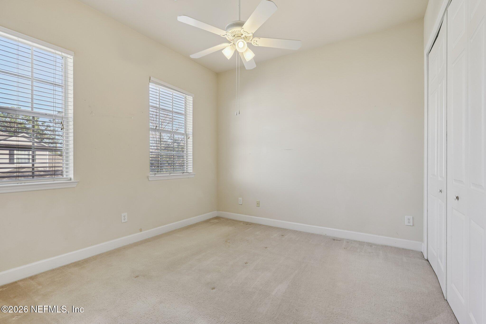 2035 Secret Garden Lane, Unit 505 Fleming Island, FL 32003 - Photo 21 of 47 an empty room with a window and a fan