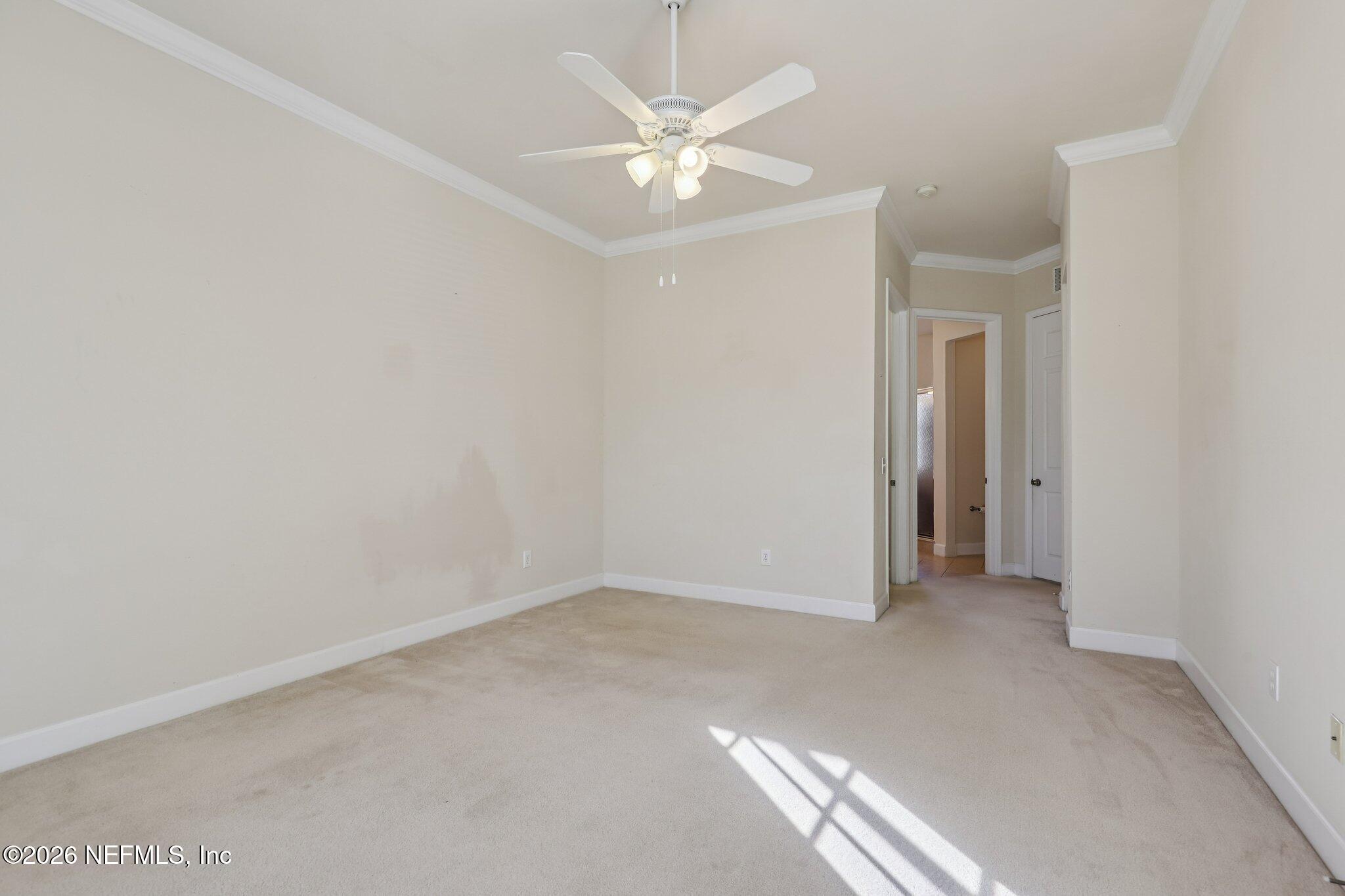 2035 Secret Garden Lane, Unit 505 Fleming Island, FL 32003 - Photo 26 of 47 an empty room with a ceiling fan and a window