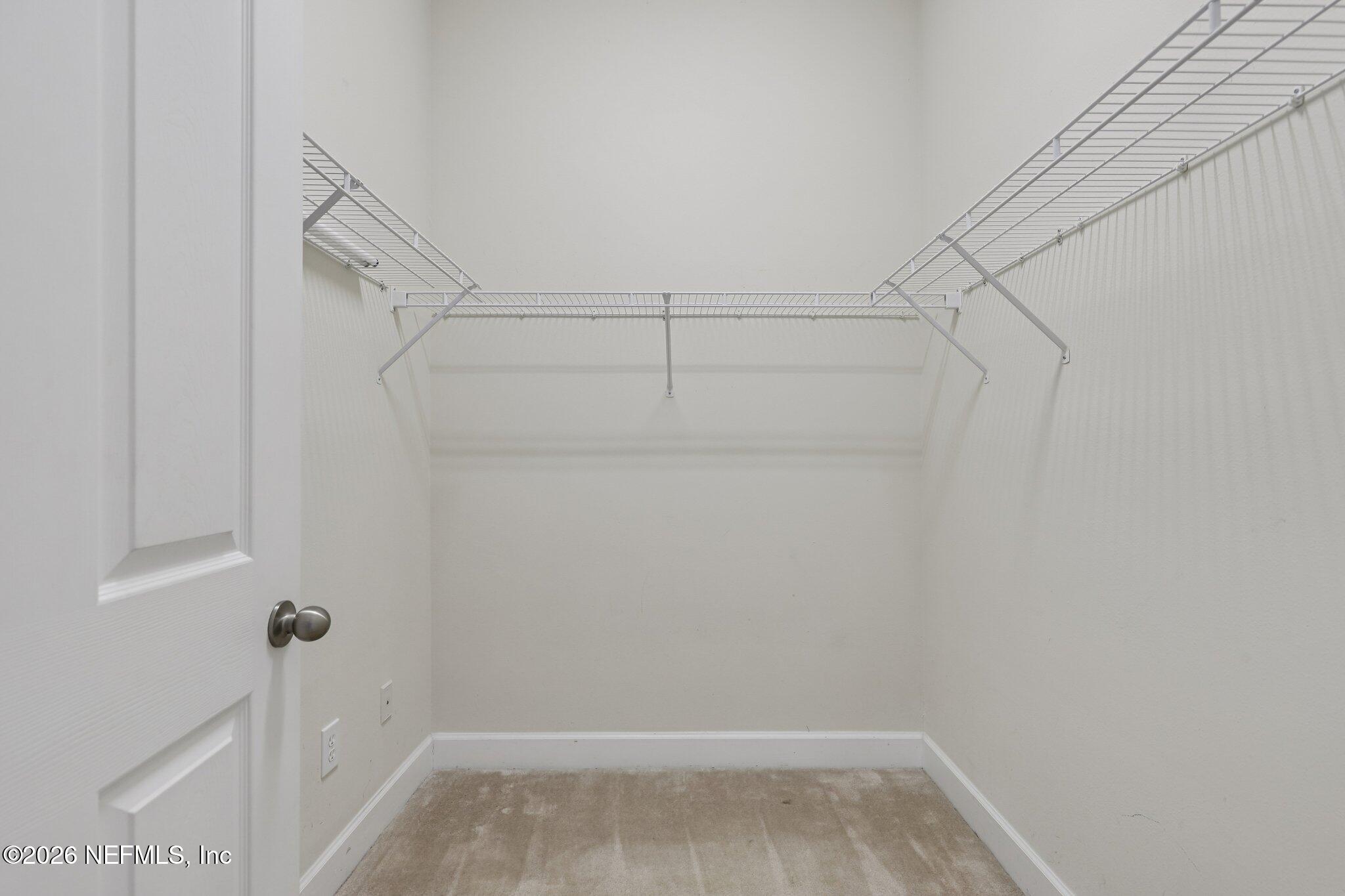 2035 Secret Garden Lane, Unit 505 Fleming Island, FL 32003 - Photo 27 of 47 a view of an empty walk in closet