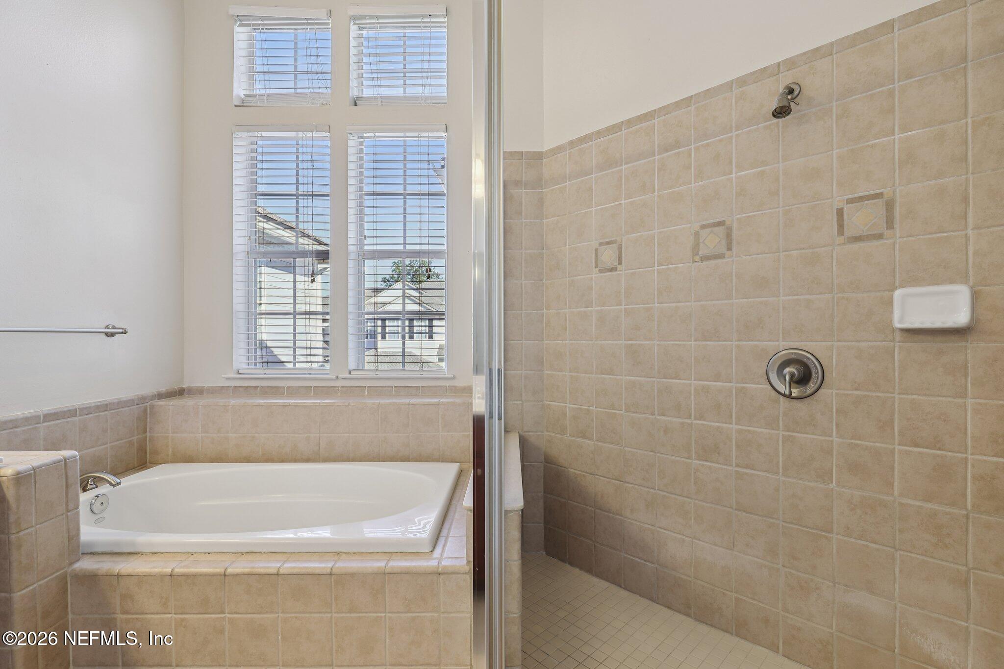 2035 Secret Garden Lane, Unit 505 Fleming Island, FL 32003 - Photo 30 of 47 a bathroom with a bathtub
