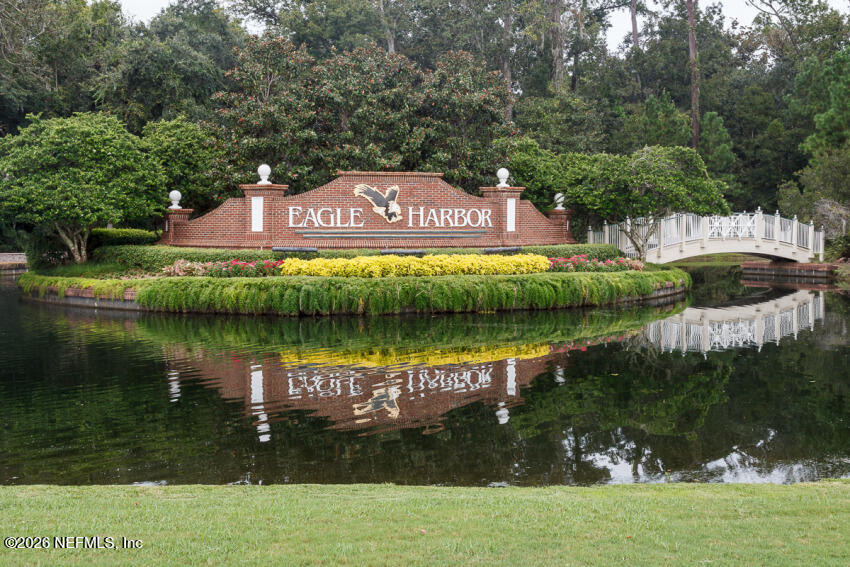 2035 Secret Garden Lane, Unit 505 Fleming Island, FL 32003 - Photo 34 of 47 a view of a lake with a building in the background