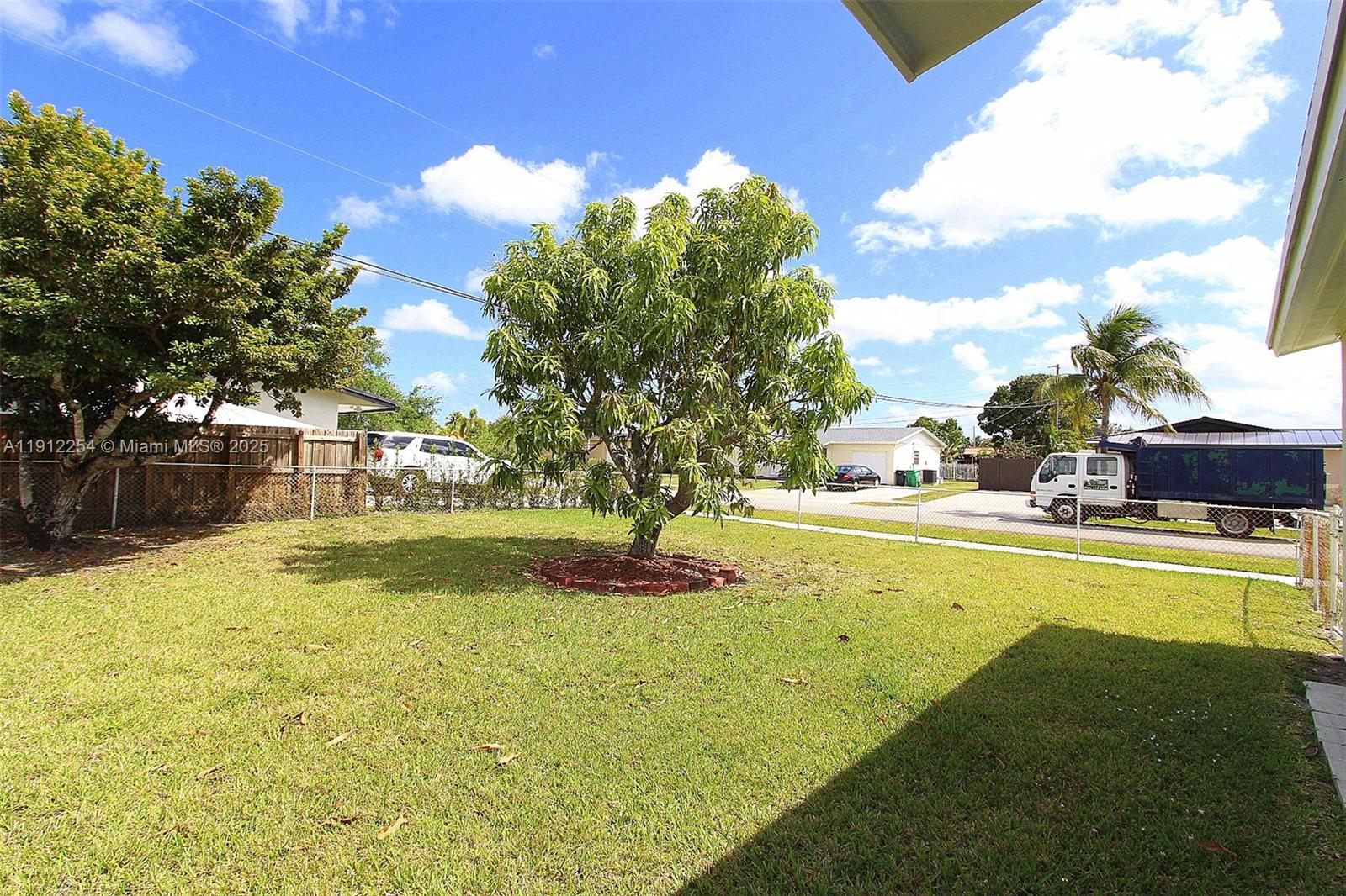 6203 Southwest 108th Place Miami, FL 33173 - Photo 18 of 23 a view of a swimming pool with an outdoor space and seating area
